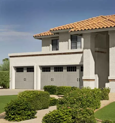 Amarr Classica carriage-house steel garage doors on a stucco home
