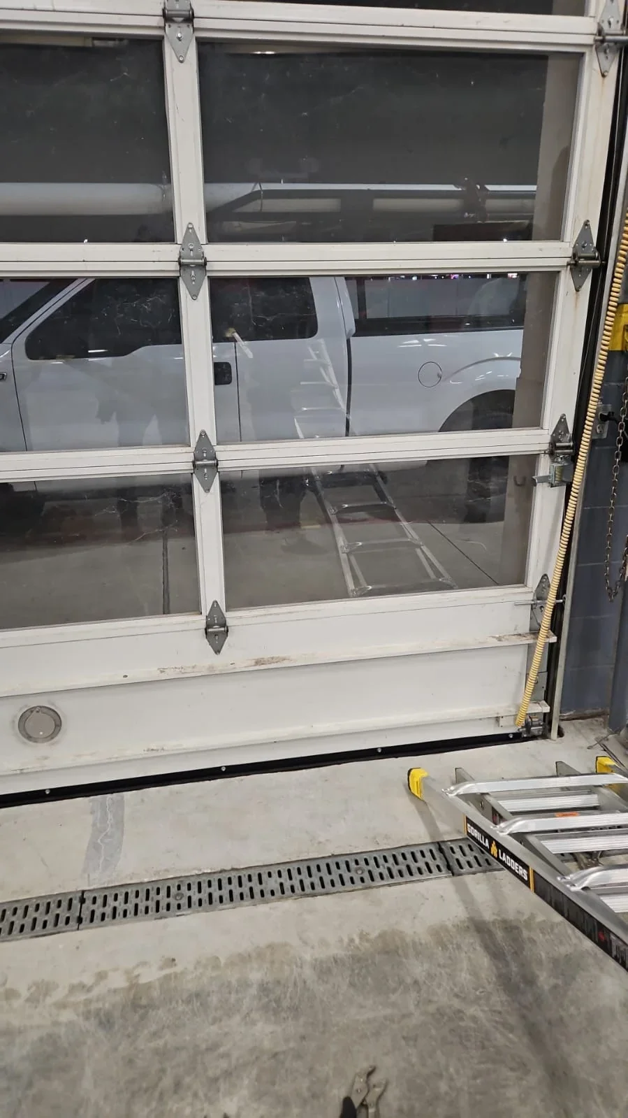 Close view of sectional garage door interior and panel hardware
