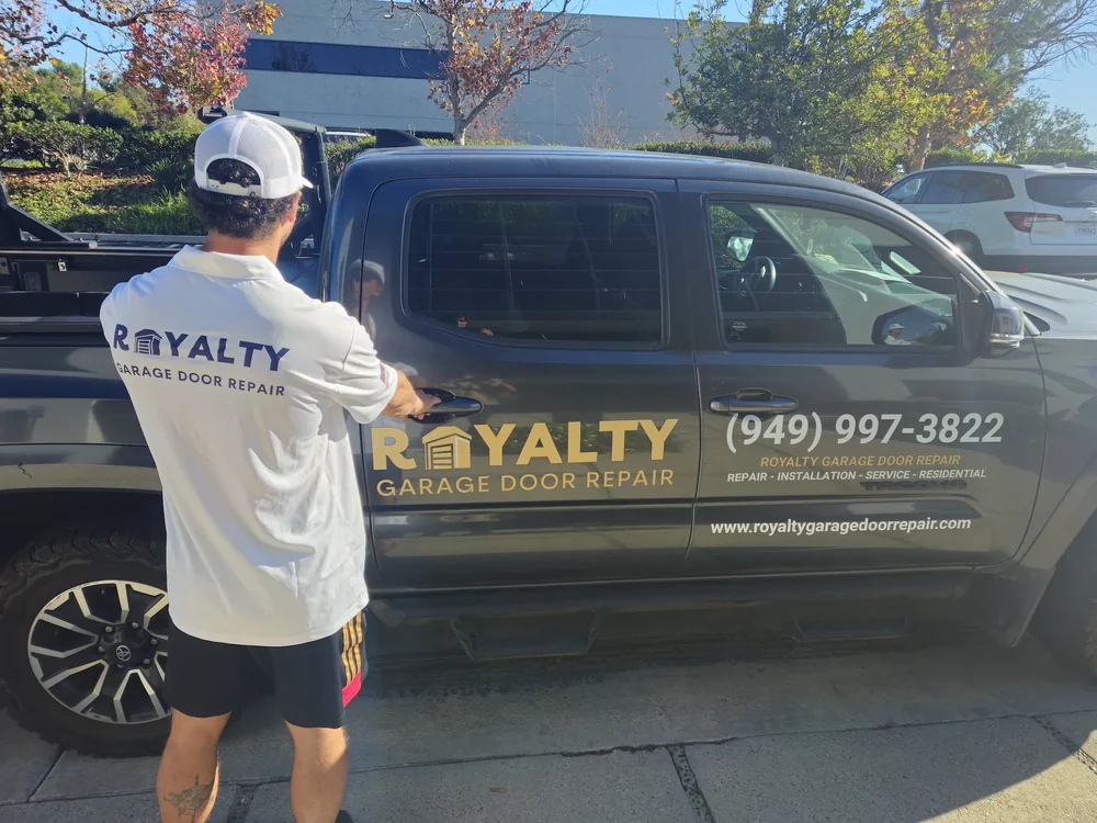 Royalty technician standing beside the branded pickup